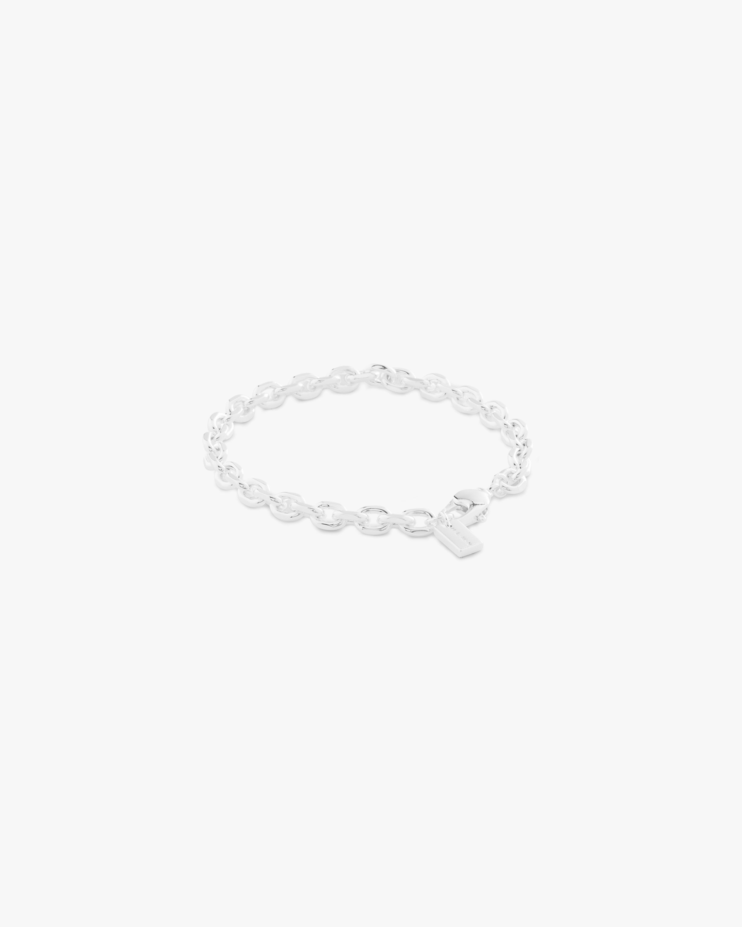Silver bracelet on a light grey background