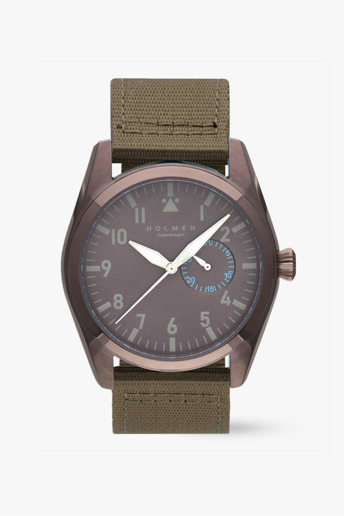 Watch with brown strap and dark face on a white background