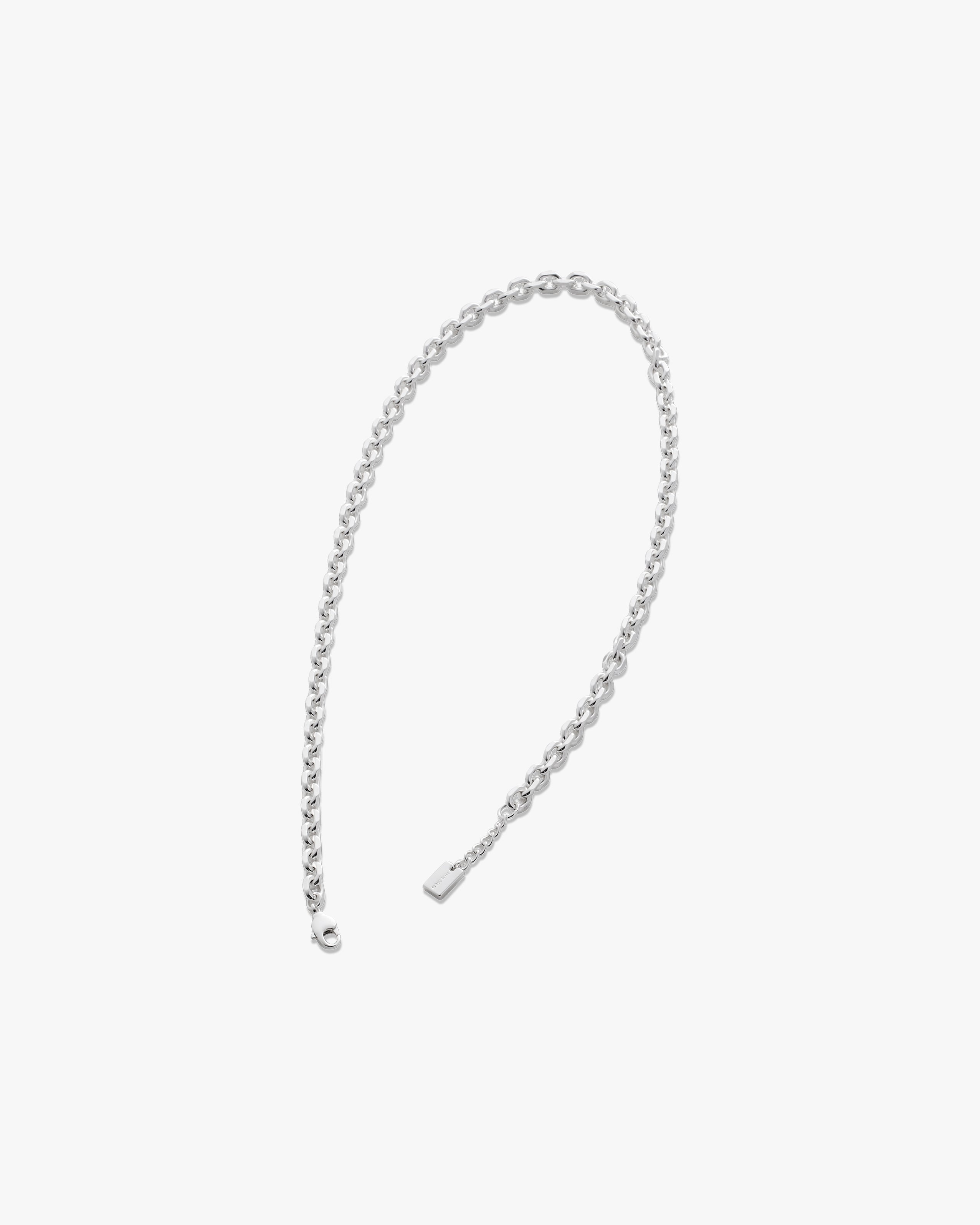 Silver chain necklace on a light gray background