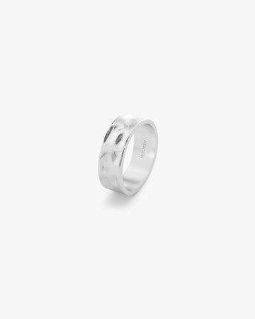Silver ring with 'HOLMEN' engraving on a light grey background