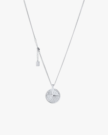 Silver compass necklace with light grey  background