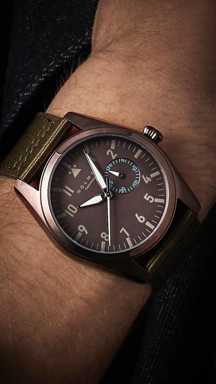 Close-up of a wrist wearing a watch with a brown leather strap.
