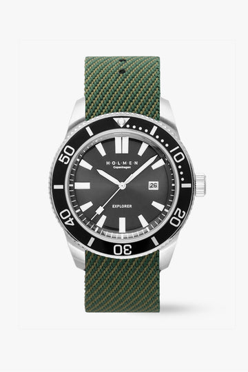 Watch with green strap and black dial on a white background