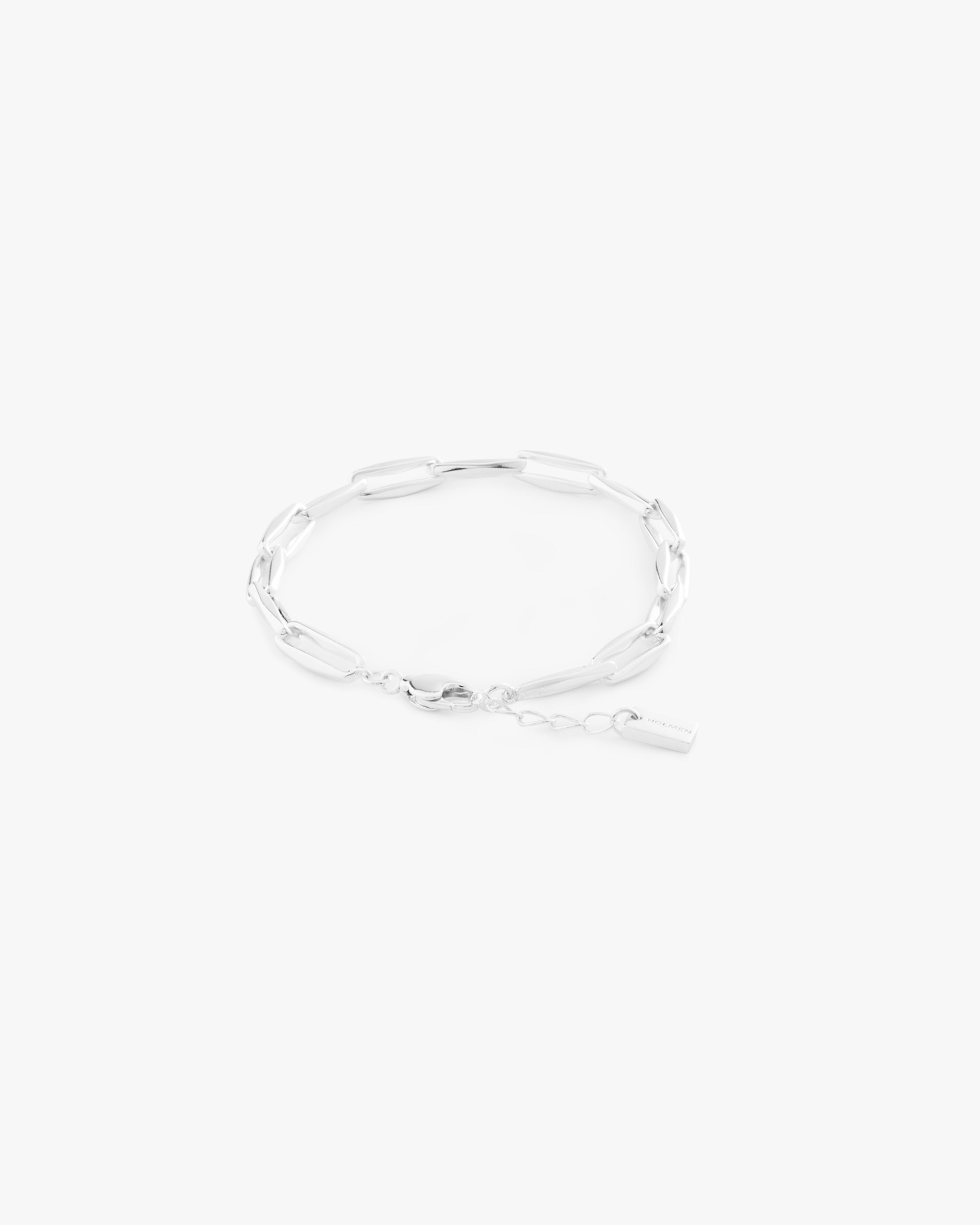 Silver bracelet on a light grey background
