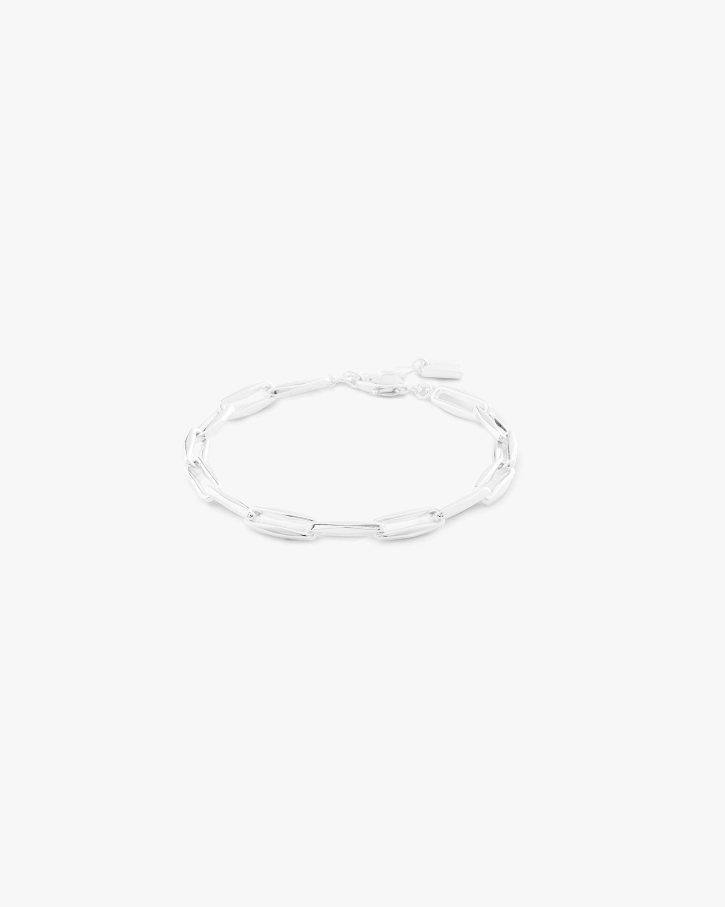Silver bracelet on a light grey background