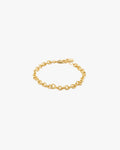 Gold chain bracelet on a light grey background