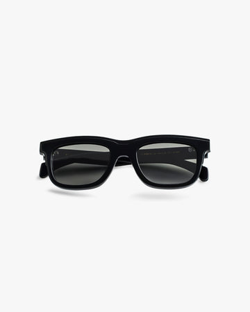 Black sunglasses on a light grey background