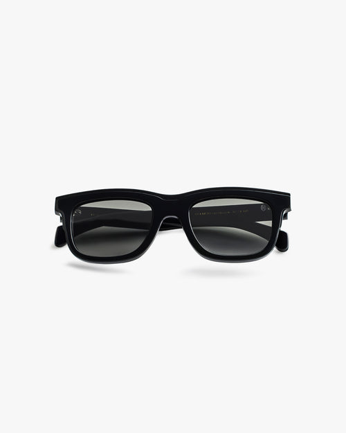 Black sunglasses on a light grey background