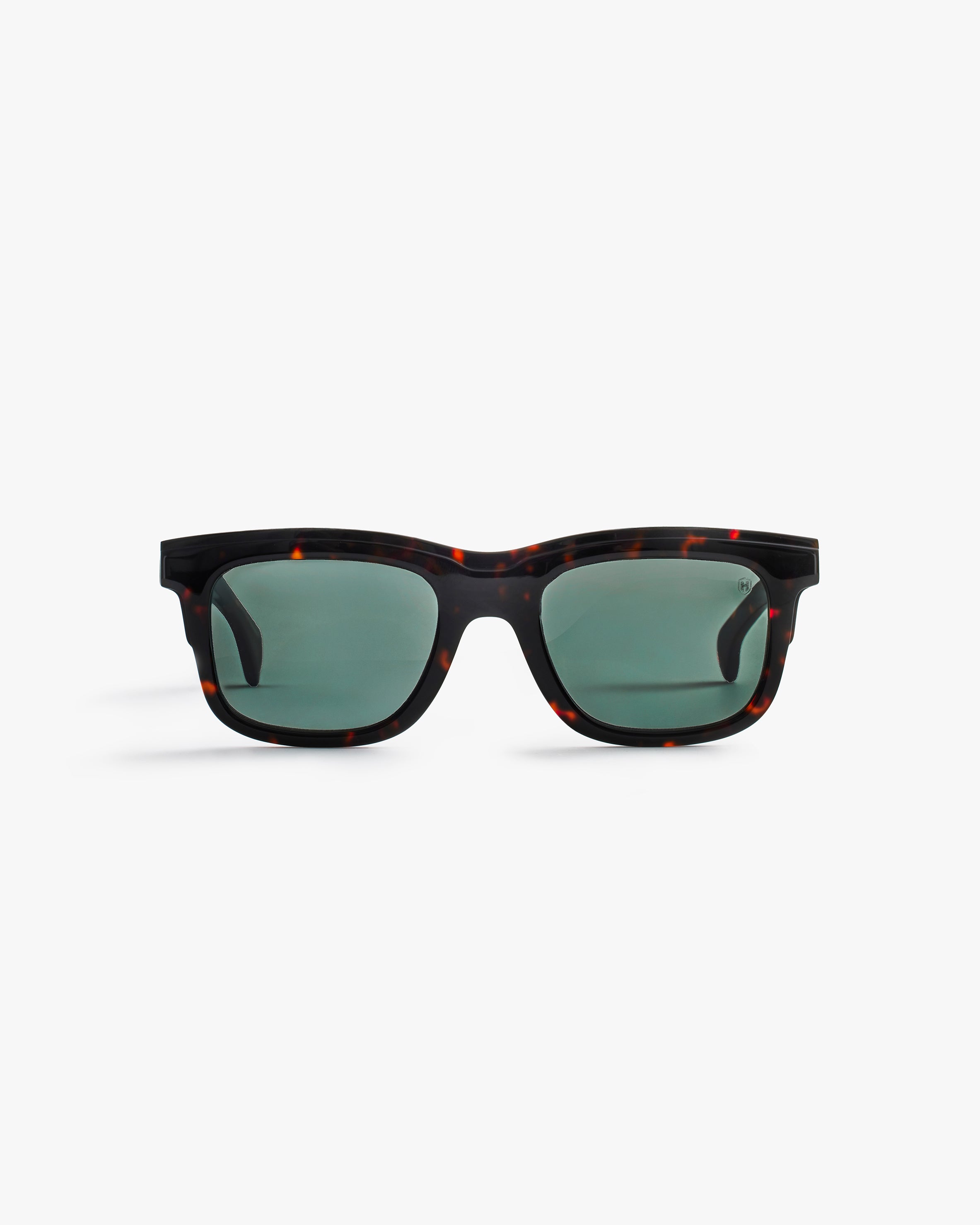 Sunglasses black structured frame and green lenses on a light grey background
