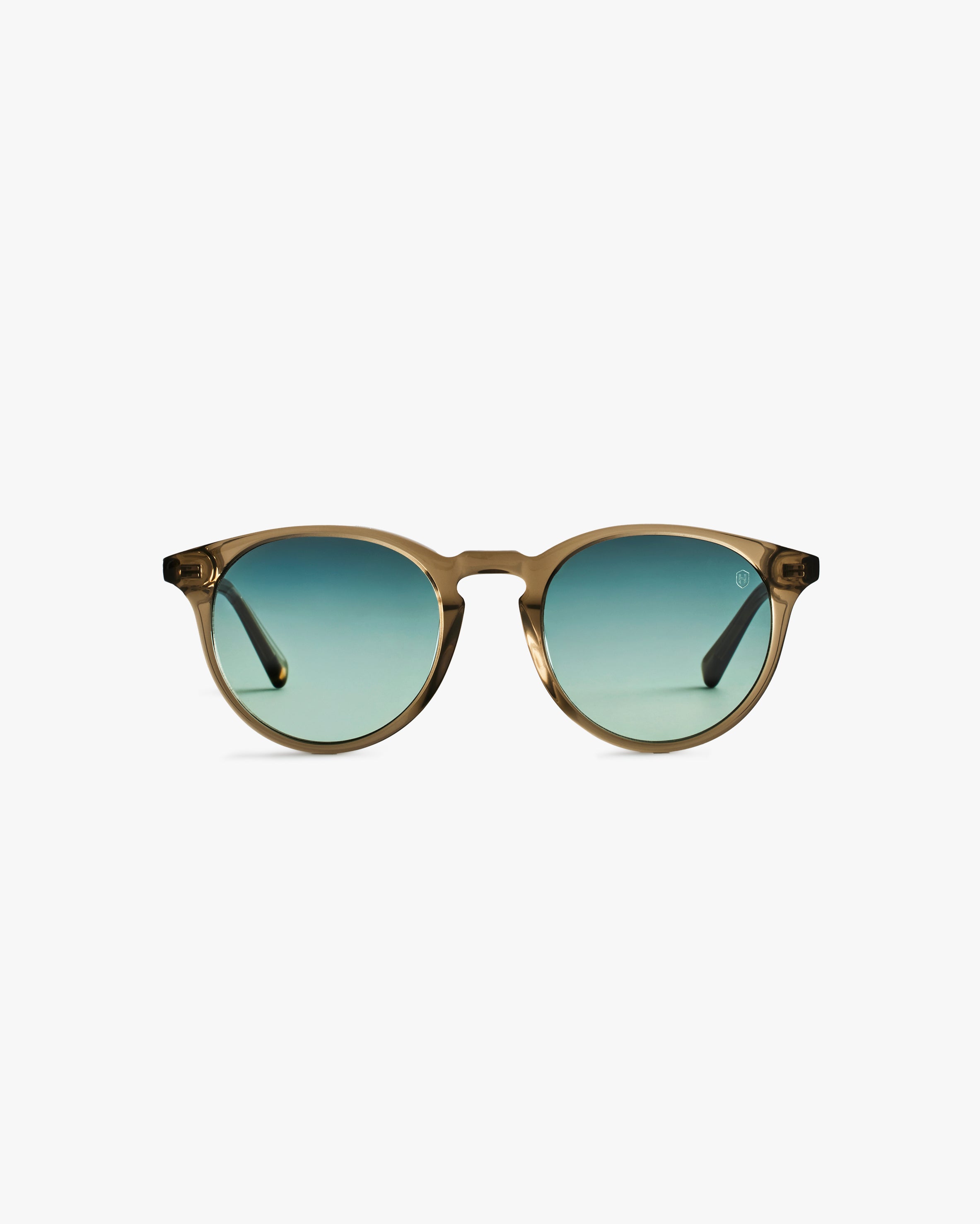 Round sunglasses with gold frame and green gradient lenses on a light grey background