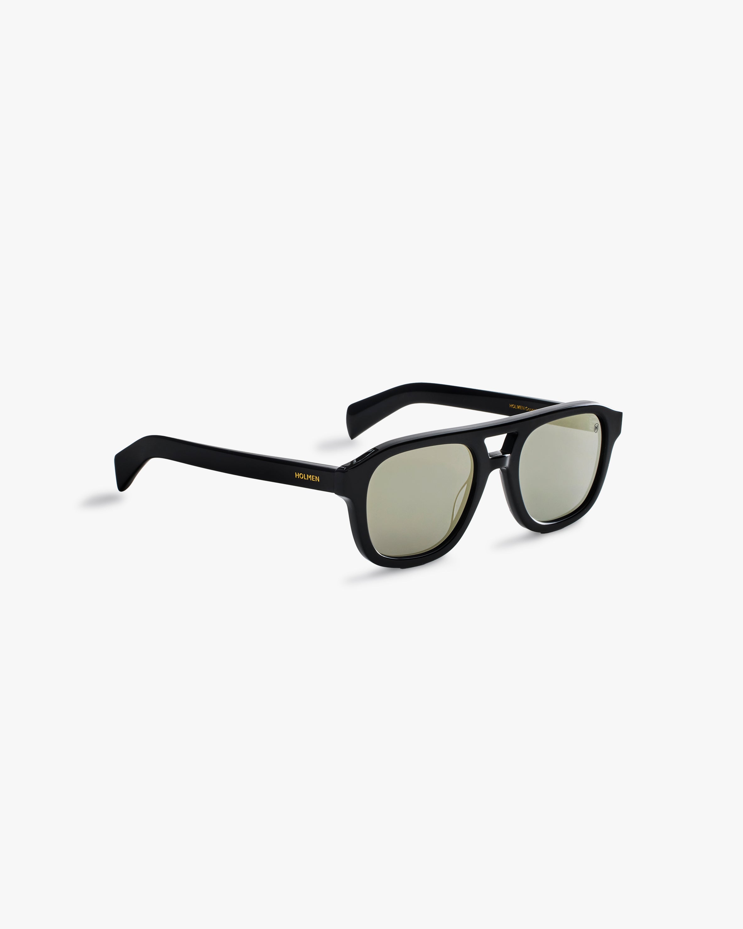 Black sunglasses with gold accents on a light grey background