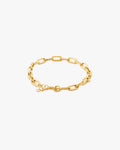 Gold chain bracelet on a light grey background