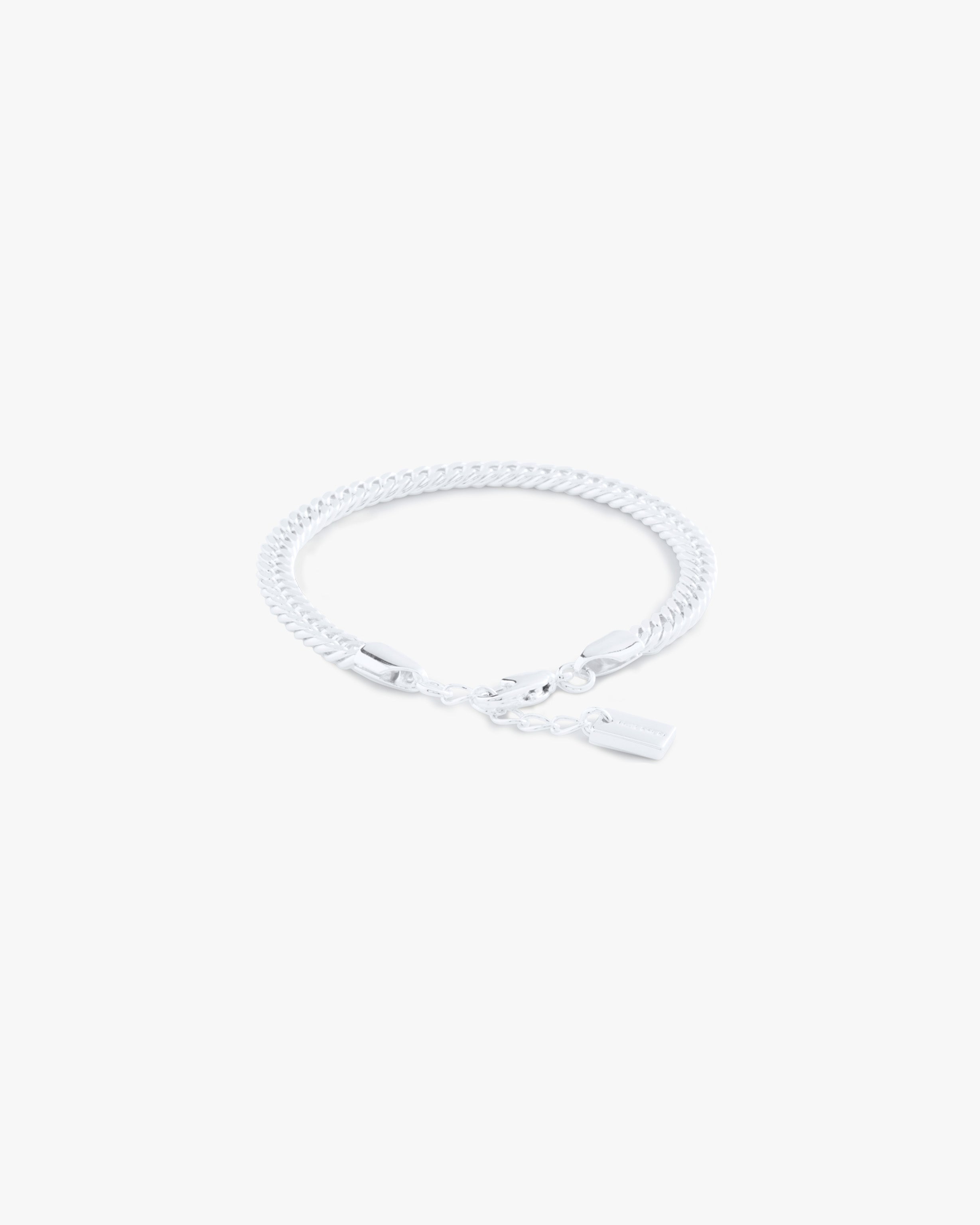Silver bracelet on a light gray background
