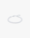 White braided bracelet on a light gray background