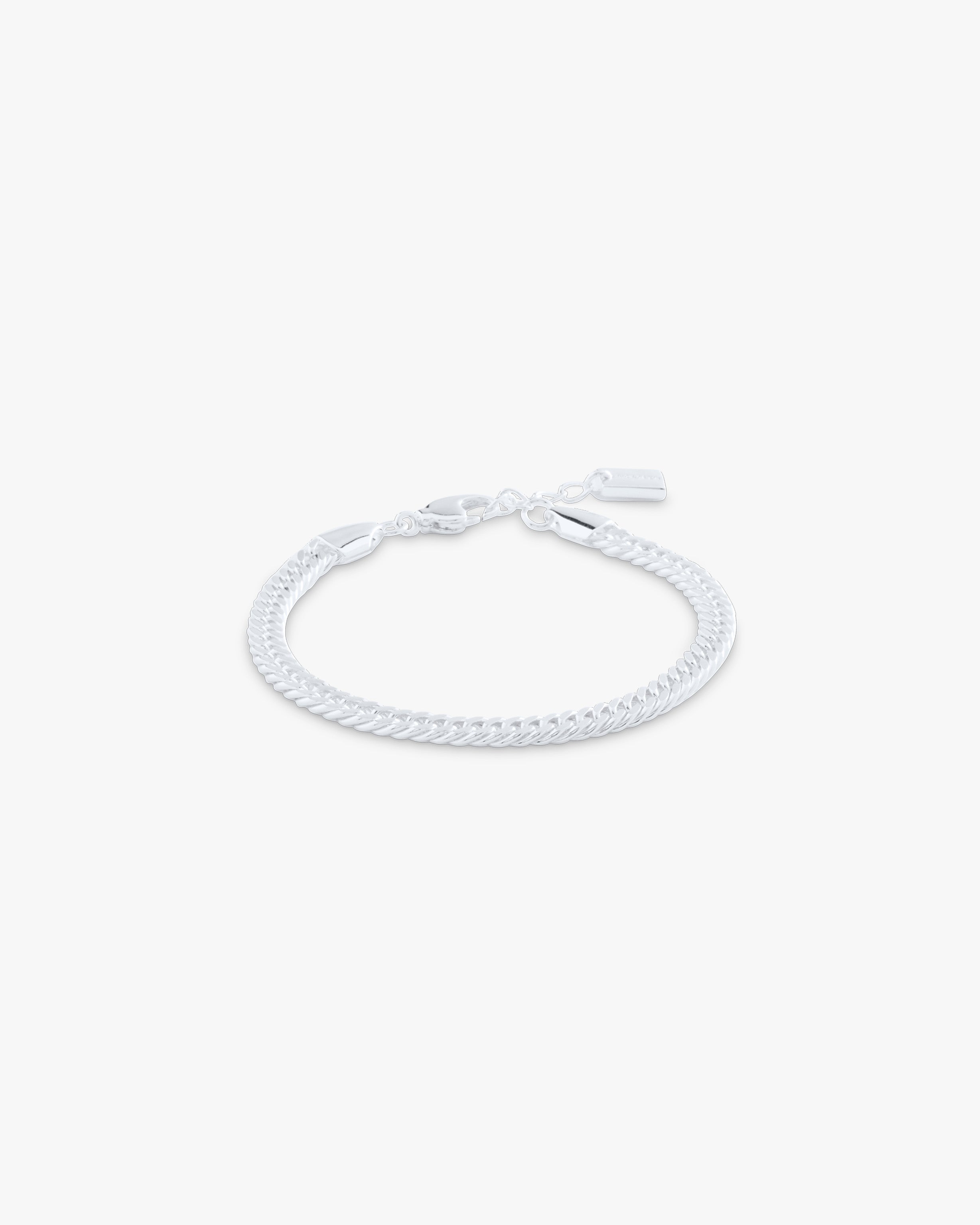 White braided bracelet on a light gray background