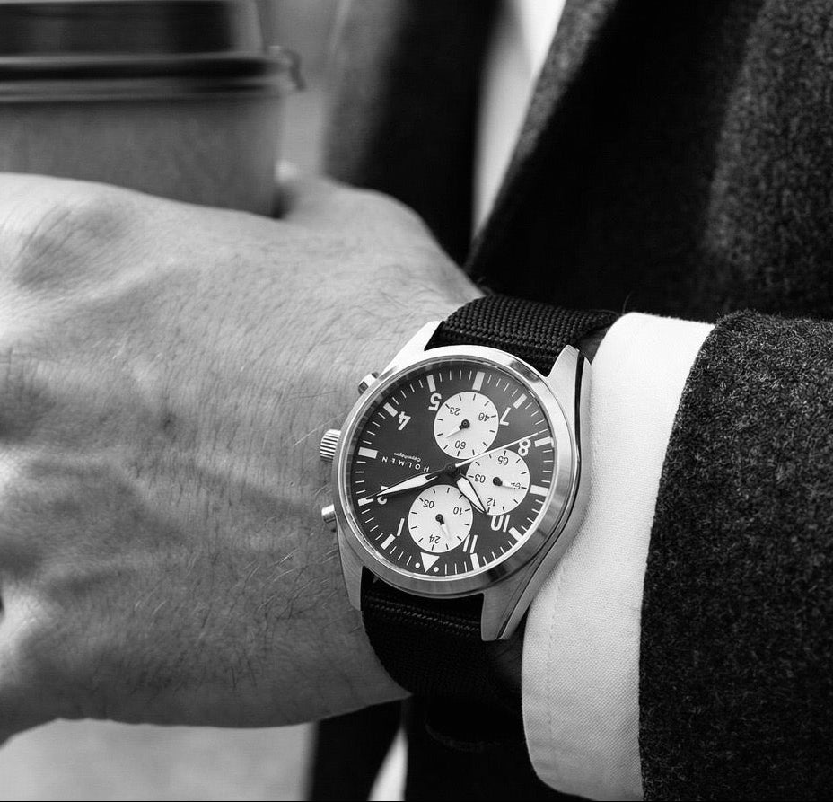 Person wearing a watch with a blurred background